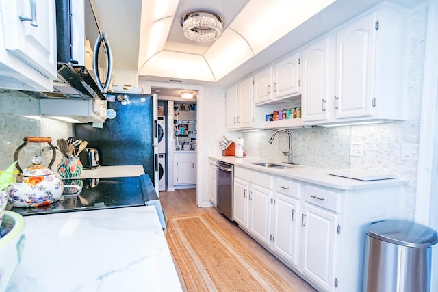 kitchen featuring white cabinetry, sink, stainless steel appliances, a raised ceiling, and light hardwood / wood-style floors