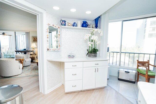 interior space with white cabinets, ceiling fan, and light hardwood / wood-style floors