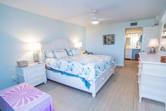 bedroom featuring ensuite bath and ceiling fan