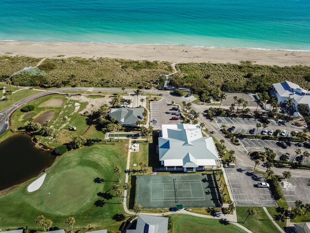 drone / aerial view featuring a beach view and a water view