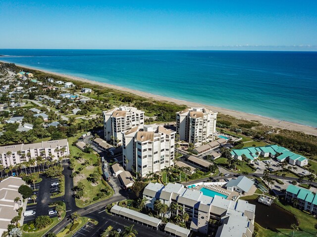 bird's eye view featuring a water view and a beach view