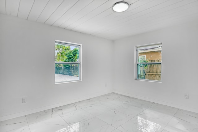 spare room featuring plenty of natural light and wooden ceiling