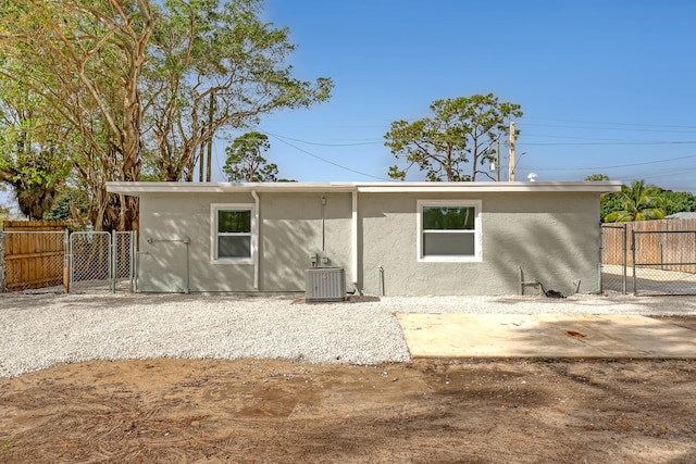 rear view of property featuring central AC