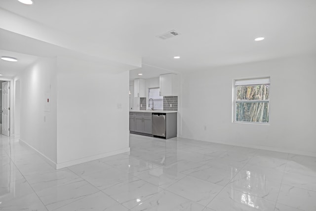 unfurnished living room featuring sink