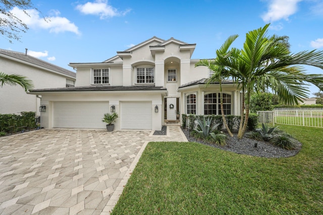 view of front of property featuring a front yard and a garage