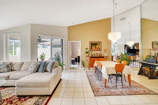 tiled living room with high vaulted ceiling and a chandelier