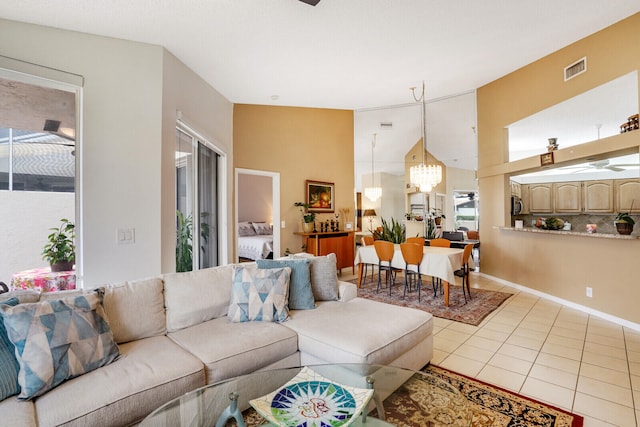 living room with a chandelier and light tile patterned floors