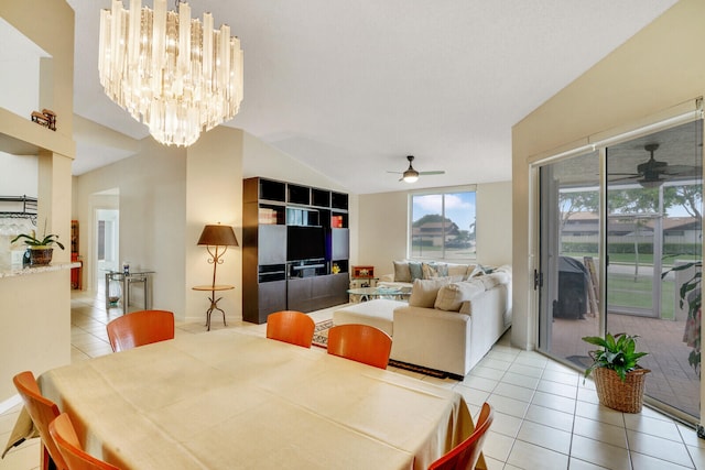 dining space featuring vaulted ceiling, ceiling fan with notable chandelier, and light tile patterned floors