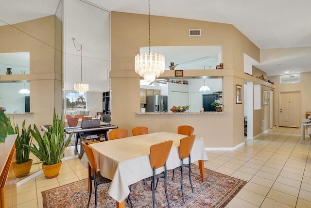 tiled dining area with high vaulted ceiling and a notable chandelier