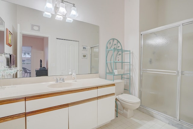 bathroom featuring walk in shower, tile patterned floors, vanity, and toilet