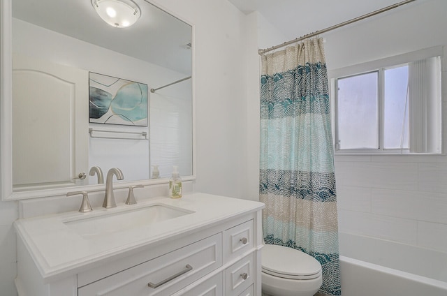 full bathroom featuring shower / tub combo with curtain, vanity, and toilet