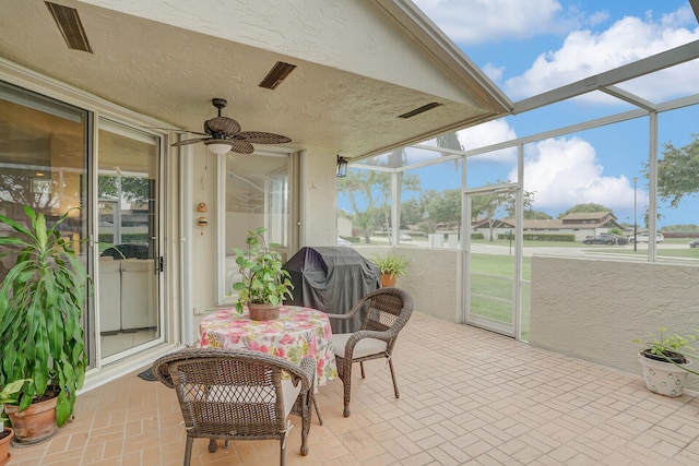 sunroom with plenty of natural light and ceiling fan