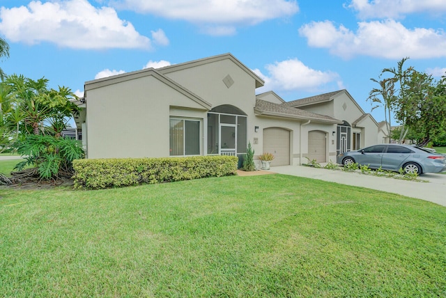 view of front facade with a garage and a front lawn