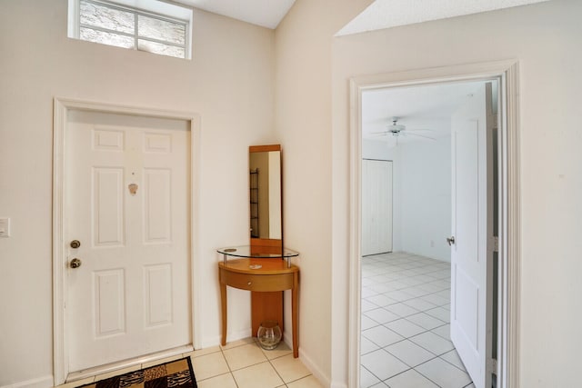 foyer with ceiling fan and light tile patterned floors