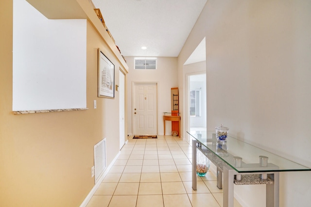 doorway to outside with light tile patterned floors