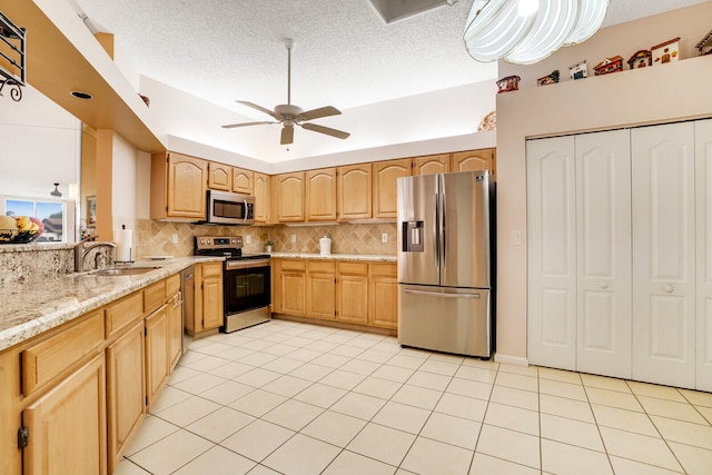 kitchen featuring tasteful backsplash, stainless steel appliances, sink, and light brown cabinets