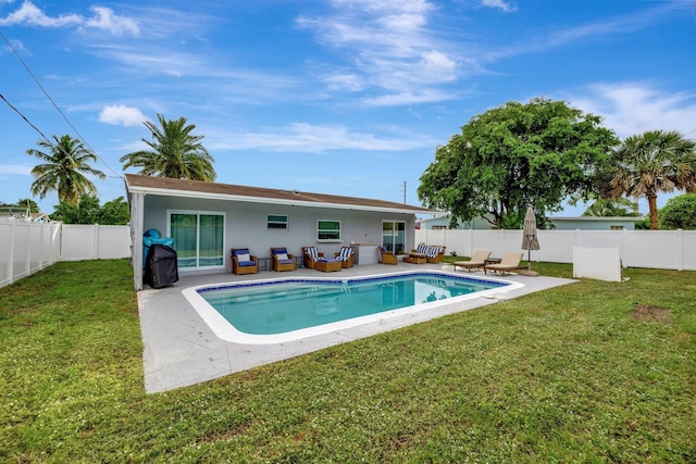 view of swimming pool with an outdoor living space, a yard, and a patio