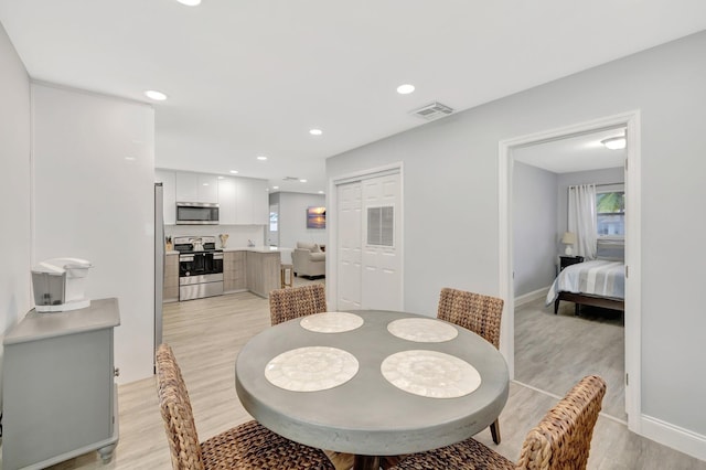 dining room with light hardwood / wood-style flooring