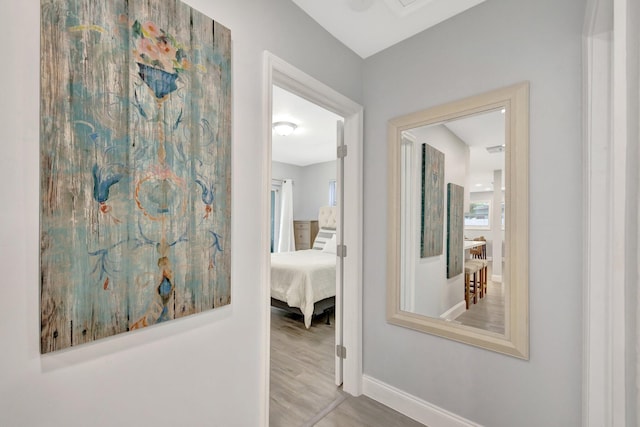 hallway with hardwood / wood-style flooring