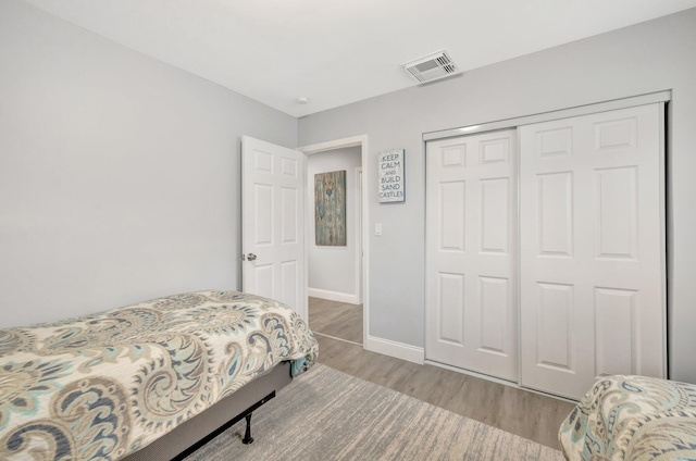 bedroom featuring hardwood / wood-style flooring and a closet