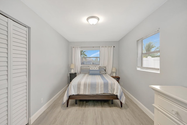 bedroom with a closet and light hardwood / wood-style flooring