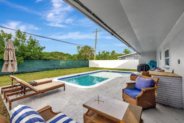 view of pool featuring a patio area and a yard