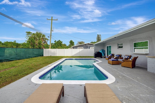 view of swimming pool with an outdoor living space, a patio, and a lawn