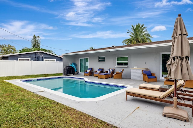 view of swimming pool featuring a grill, a patio area, an outdoor hangout area, and a yard