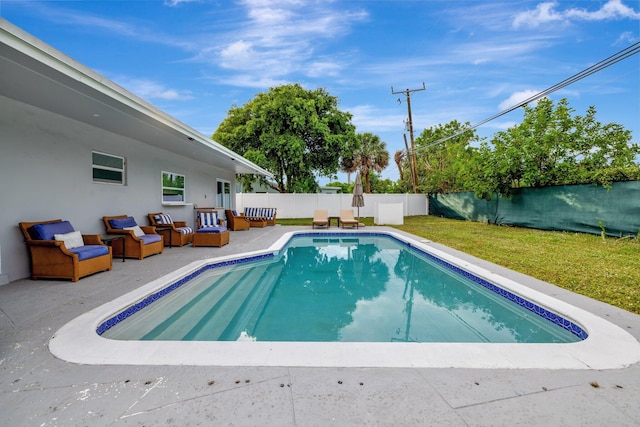 view of pool featuring a lawn, an outdoor hangout area, and a patio