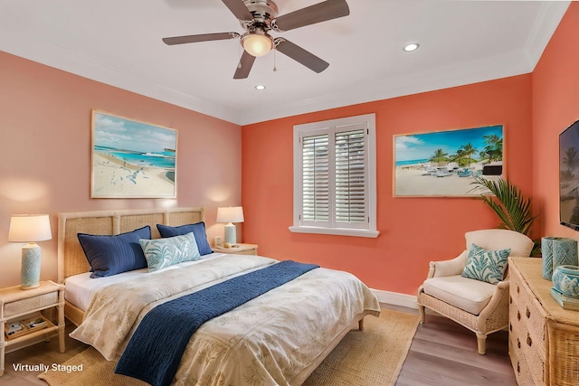 bedroom featuring ceiling fan, crown molding, and hardwood / wood-style floors