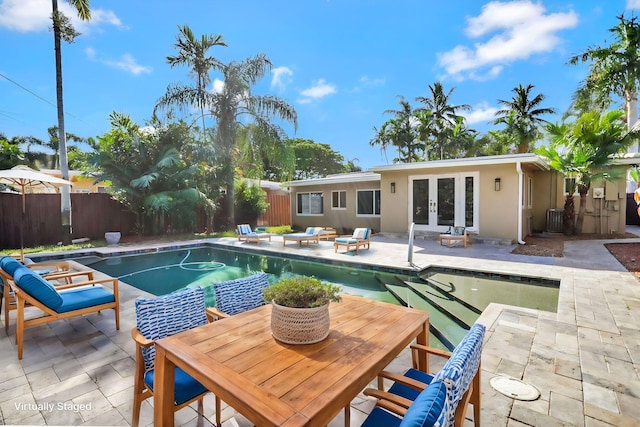 view of swimming pool with a patio area and french doors