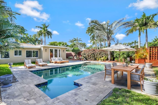 view of pool with french doors and a patio