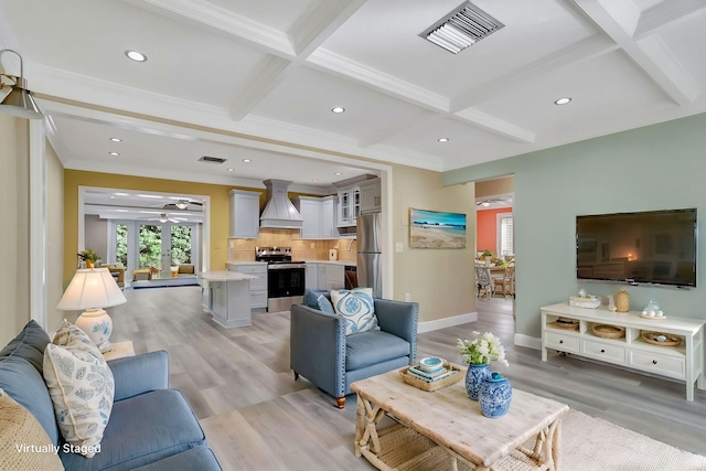 living room featuring light hardwood / wood-style floors, coffered ceiling, ceiling fan, crown molding, and beamed ceiling