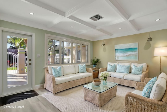 living room featuring a healthy amount of sunlight, coffered ceiling, and light hardwood / wood-style floors