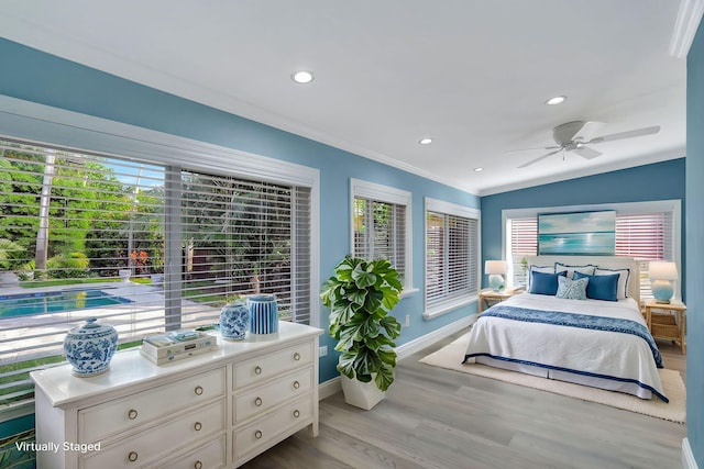 bedroom featuring ceiling fan, vaulted ceiling, ornamental molding, and light hardwood / wood-style floors