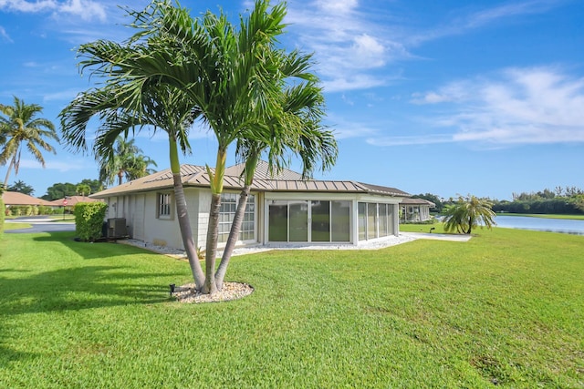 330 Cedar Key Cir, Atlantis, FL 33462 - rear view of property with central air condition unit, a standing seam roof, a lawn, a sunroom, and metal roof