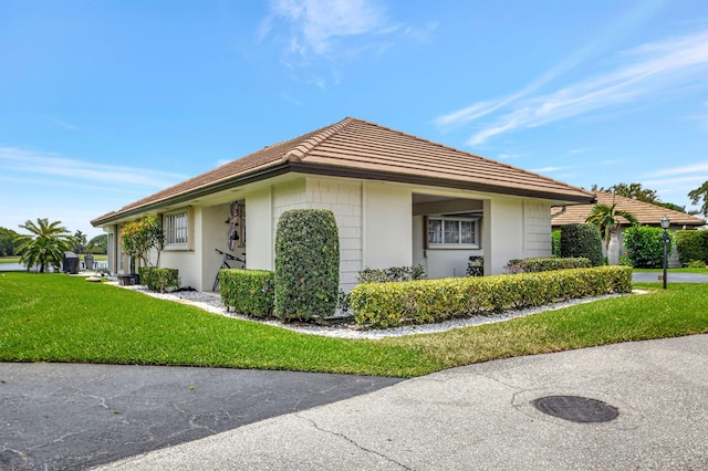 330 Cedar Key Cir, Atlantis, FL 33462 - view of side of property with stucco siding and a lawn