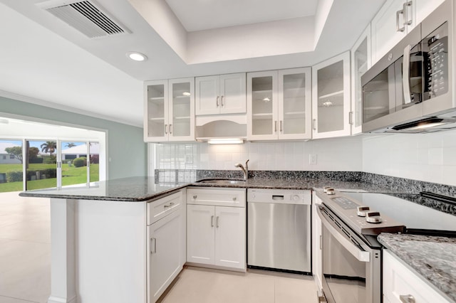 330 Cedar Key Cir, Atlantis, FL 33462 - kitchen featuring appliances with stainless steel finishes, a sink, a peninsula, white cabinetry, and visible vents