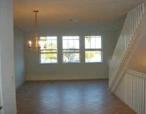 empty room featuring a chandelier