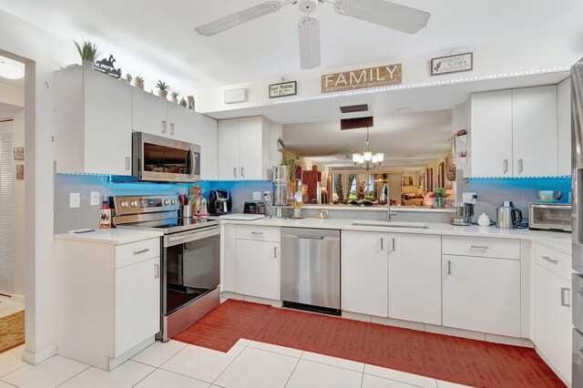 9668 Sills Dr Unit 101, Boynton Beach, FL 33437 - kitchen featuring appliances with stainless steel finishes, a sink, light tile patterned flooring, and tasteful backsplash
