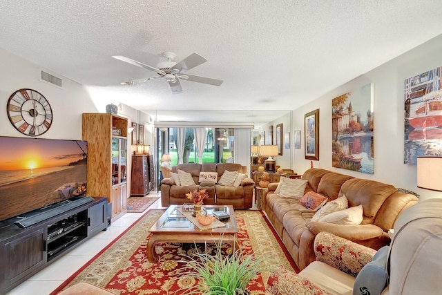 9668 Sills Dr Unit 101, Boynton Beach, FL 33437 - living area featuring light tile patterned floors, a textured ceiling, and a ceiling fan