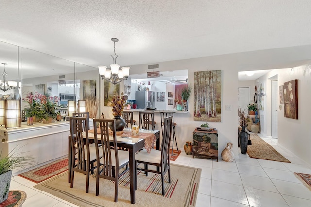 9668 Sills Dr Unit 101, Boynton Beach, FL 33437 - tiled dining area with a chandelier, a textured ceiling, and ceiling fan