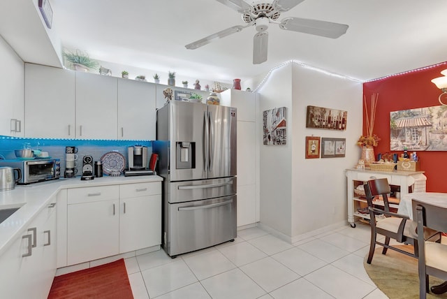 kitchen with ceiling fan, light tile patterned floors, tasteful backsplash, stainless steel fridge with ice dispenser, and white cabinets