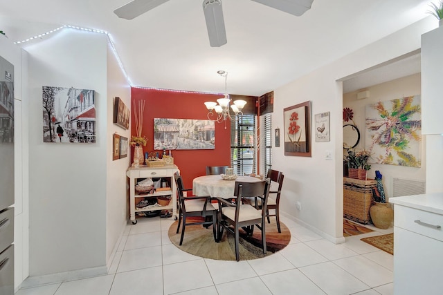 dining room featuring ceiling fan with notable chandelier and light tile patterned flooring