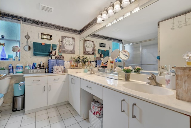 bathroom featuring tile patterned flooring, vanity, and walk in shower