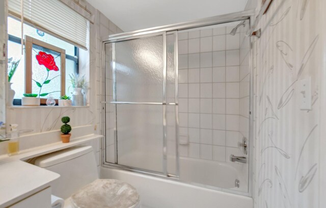 9668 Sills Dr Unit 101, Boynton Beach, FL 33437 - full bath featuring vanity, shower / bath combination with glass door, and toilet