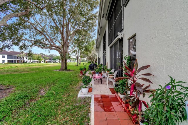 9668 Sills Dr Unit 101, Boynton Beach, FL 33437 - view of green lawn featuring a patio area