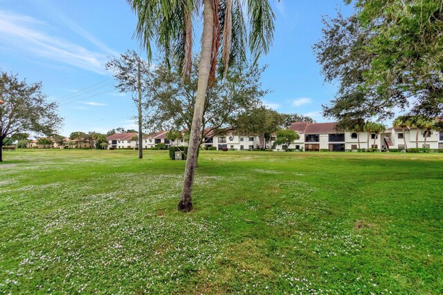 9668 Sills Dr Unit 101, Boynton Beach, FL 33437 - view of green lawn featuring a residential view