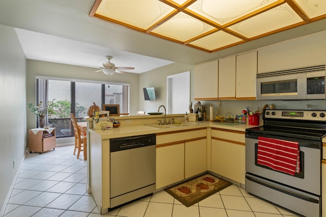 kitchen with kitchen peninsula, appliances with stainless steel finishes, ceiling fan, sink, and light tile patterned floors