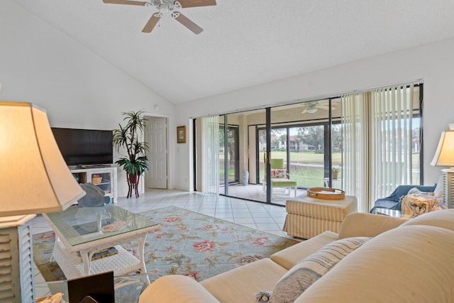 tiled living room with ceiling fan, high vaulted ceiling, and a textured ceiling